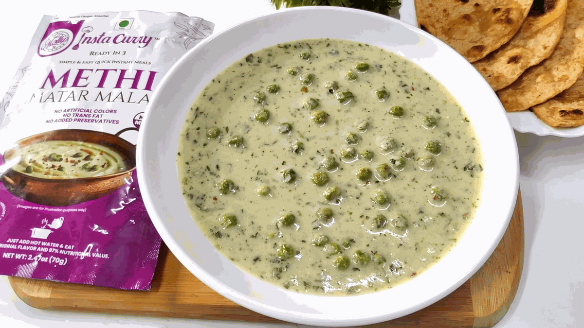 Methi Matar Malai creamy pale green curry with fenugreek leaves and green peas, served with flatbreads