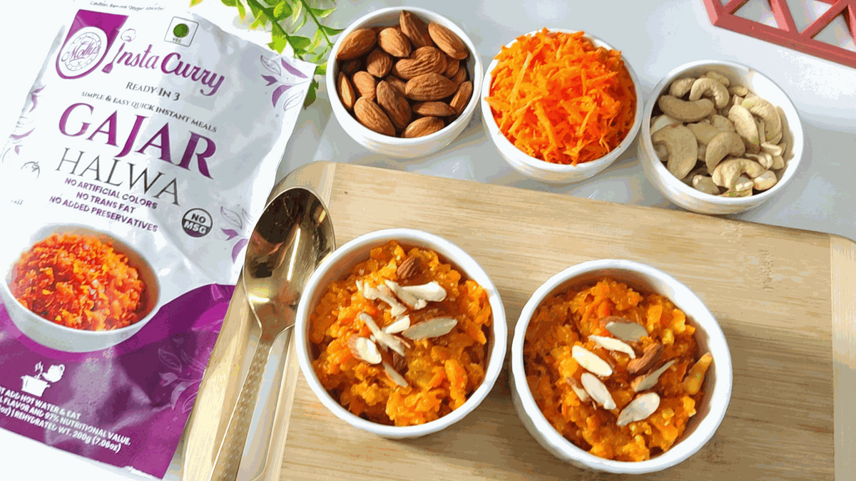 Tawa Pulao meal bundle image showing a Gajar Halwa pouch and two bowls of orange carrot dessert topped with nuts