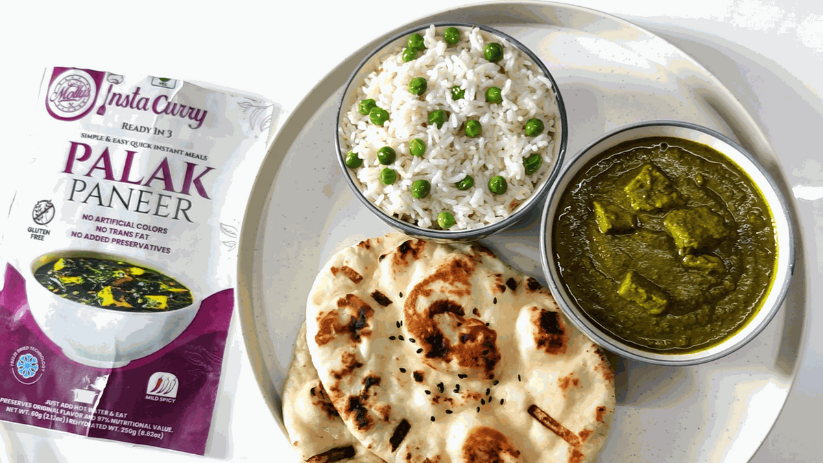Tawa Pulao meal kit showing a Palak Paneer pouch beside a plate of rice with peas, spinach curry and naan