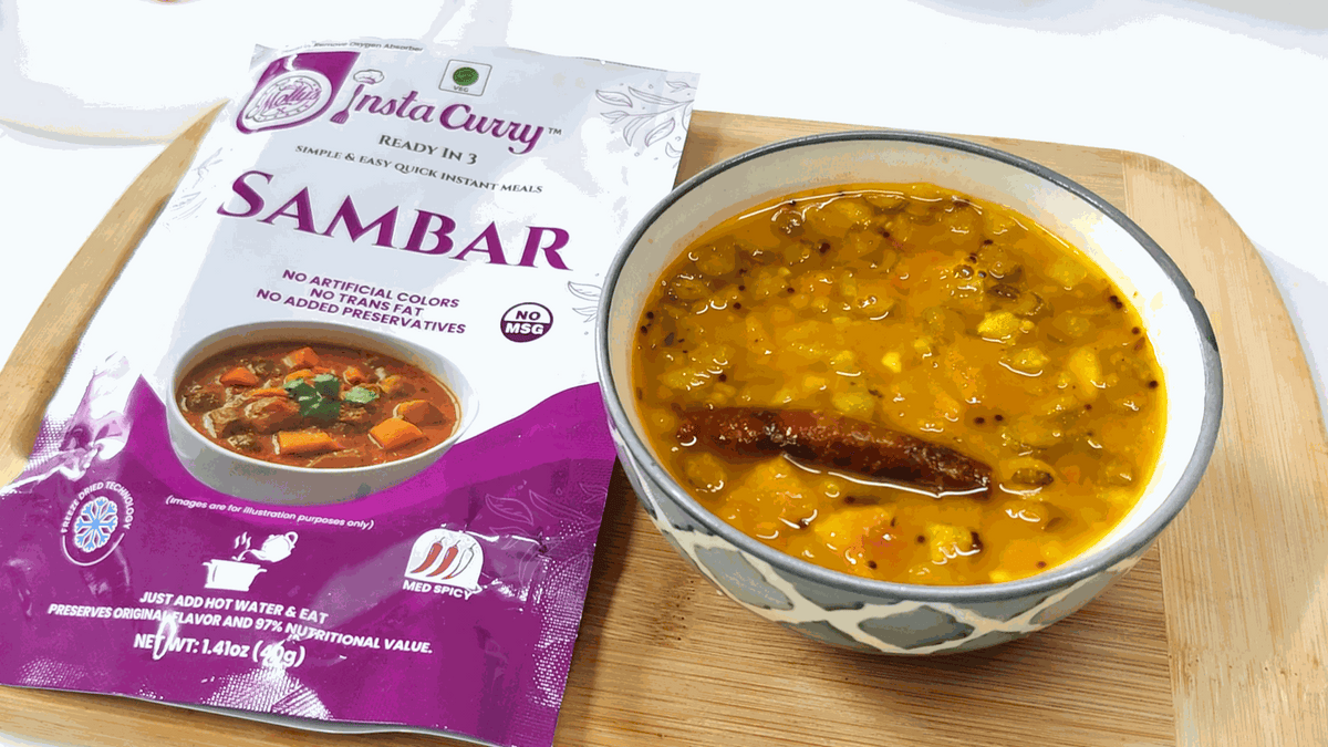 Tawa Pulao meal assortment featuring a purple Insta Curry Sambar pouch beside a bowl of golden lentil stew